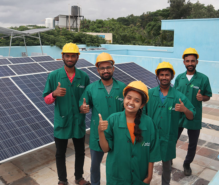 group-standing-near-solar-panel