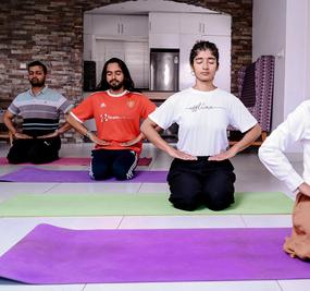 participants of happiness program doing pranayama in a room