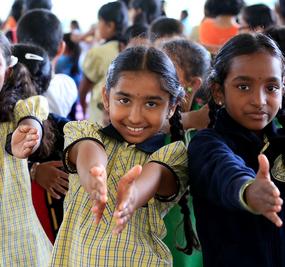 school students extending hands