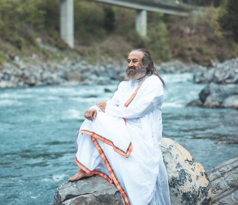 Gurudev sitting on rock on the bank of Ganga