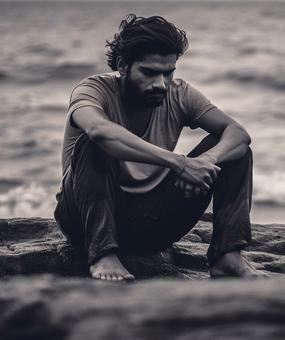 Man-depression-near rock-and-sea