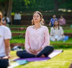 group meditation in lawn girl smiling at blr ashram