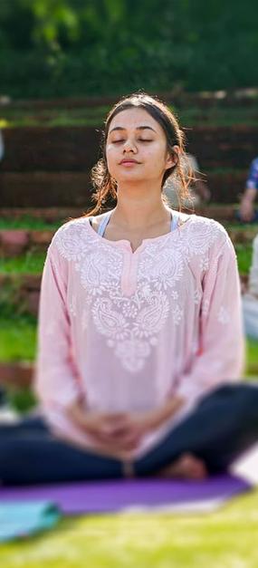 group meditation in lawn girl smiling at blr ashram