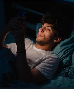 Meditation to break bad habits man scrolling on mobile while sleeping