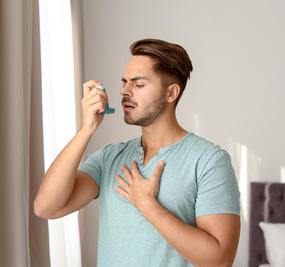 Healing Asthma with Ayurveda man with inhaler